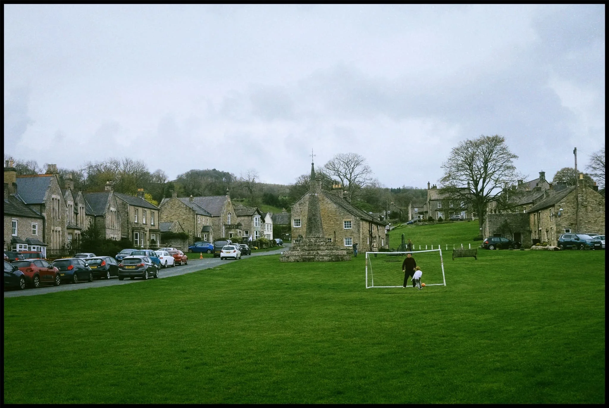  Back at the village green, father and son enjoy a kickabout. 