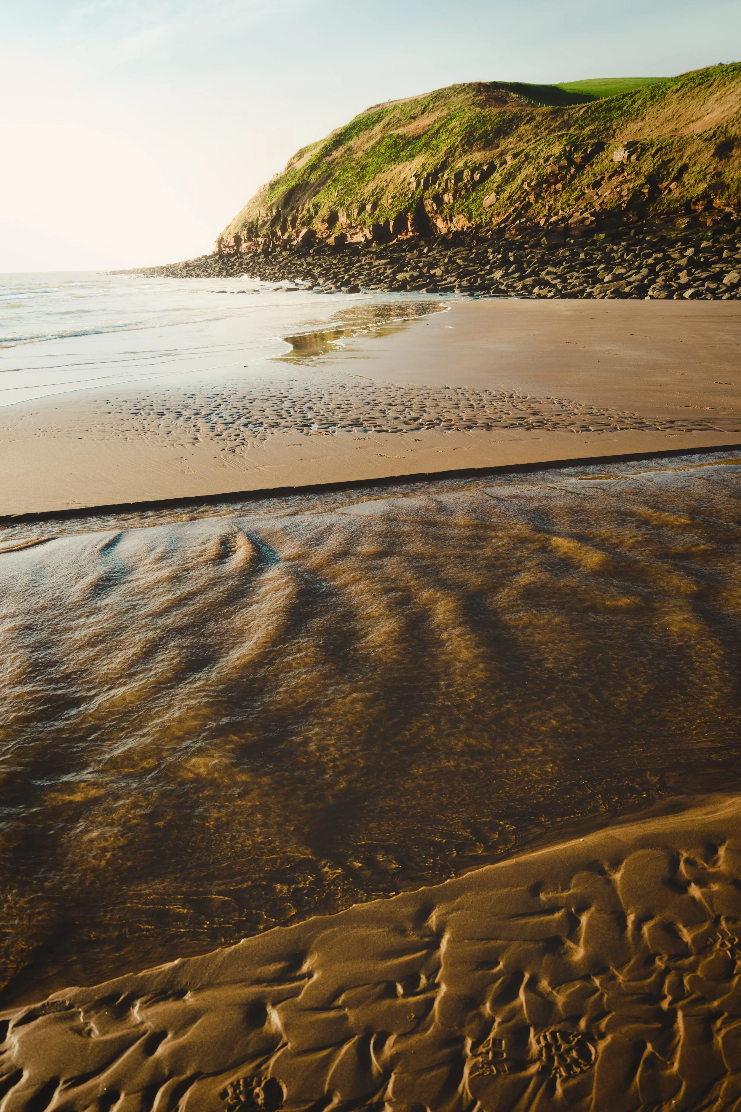  Golden sunset light. River channels cut through the beach and drain into the sea. St. Bees Head remains steadfast. 