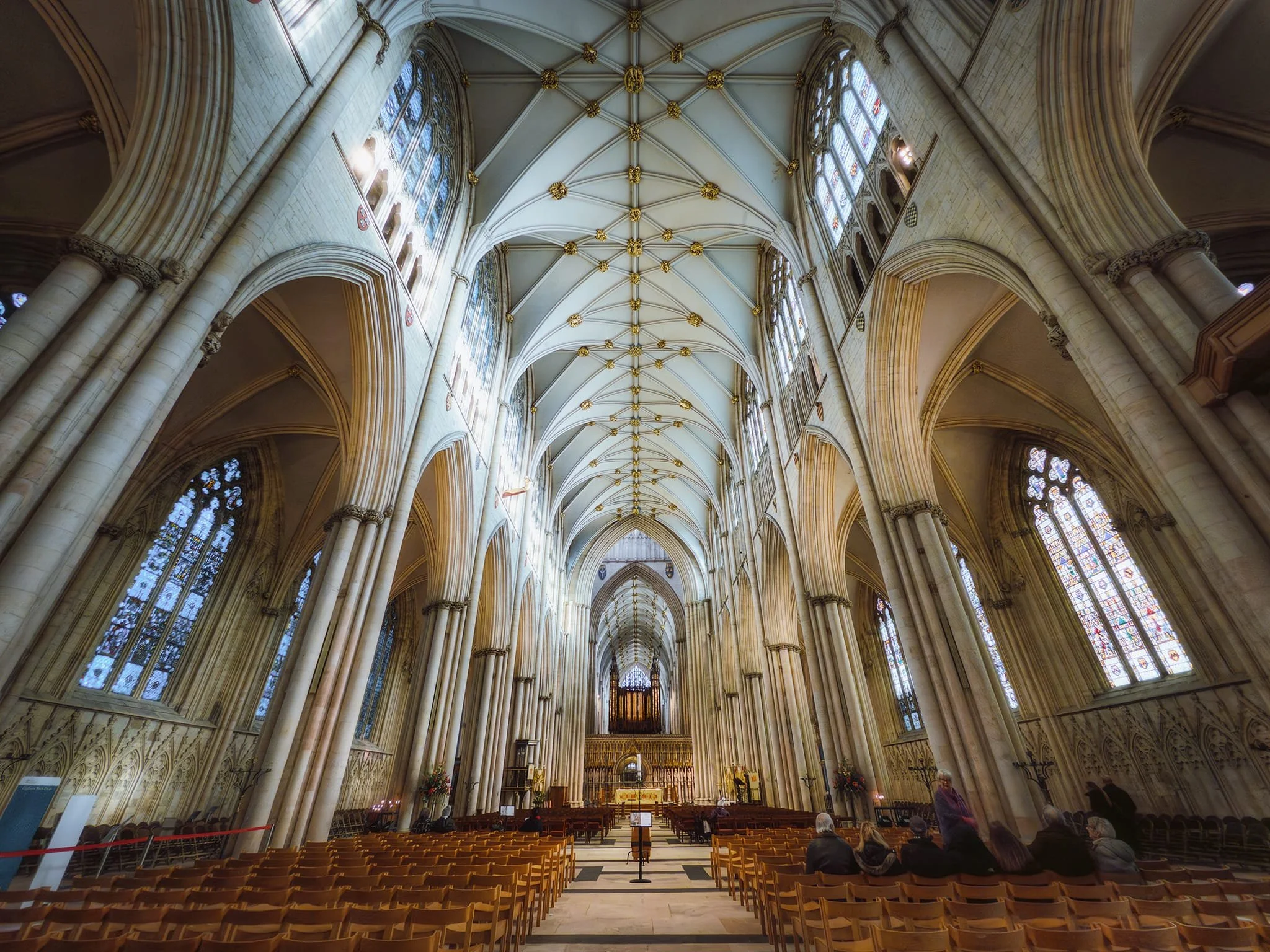 Looking all the way down York Minster’s nave. Built between 1291 and c. 1350 in the Decorated Gothic style, the nave is England’s widest Gothic nave, featuring a wooden roof painted to resemble stone and stone-vaulted aisles.