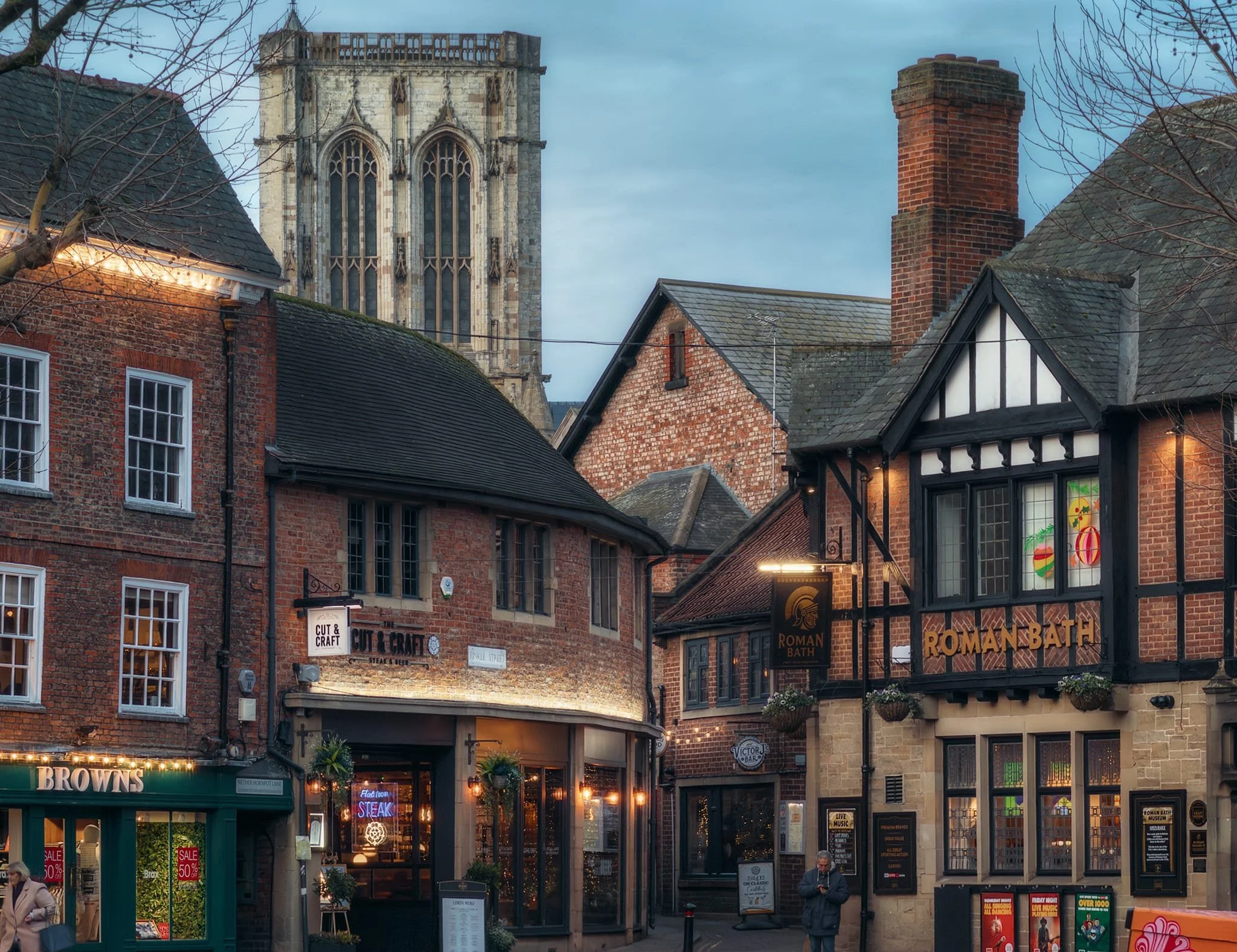 A quiet evening moment in St. Sampson’s Square, looking towards Finkle Street and the Minster. St. Sampson’s Square was historically a main retail space and a market was held here each Thursday. The Roman Bath Pub actually has a small Roman museum in its basement.